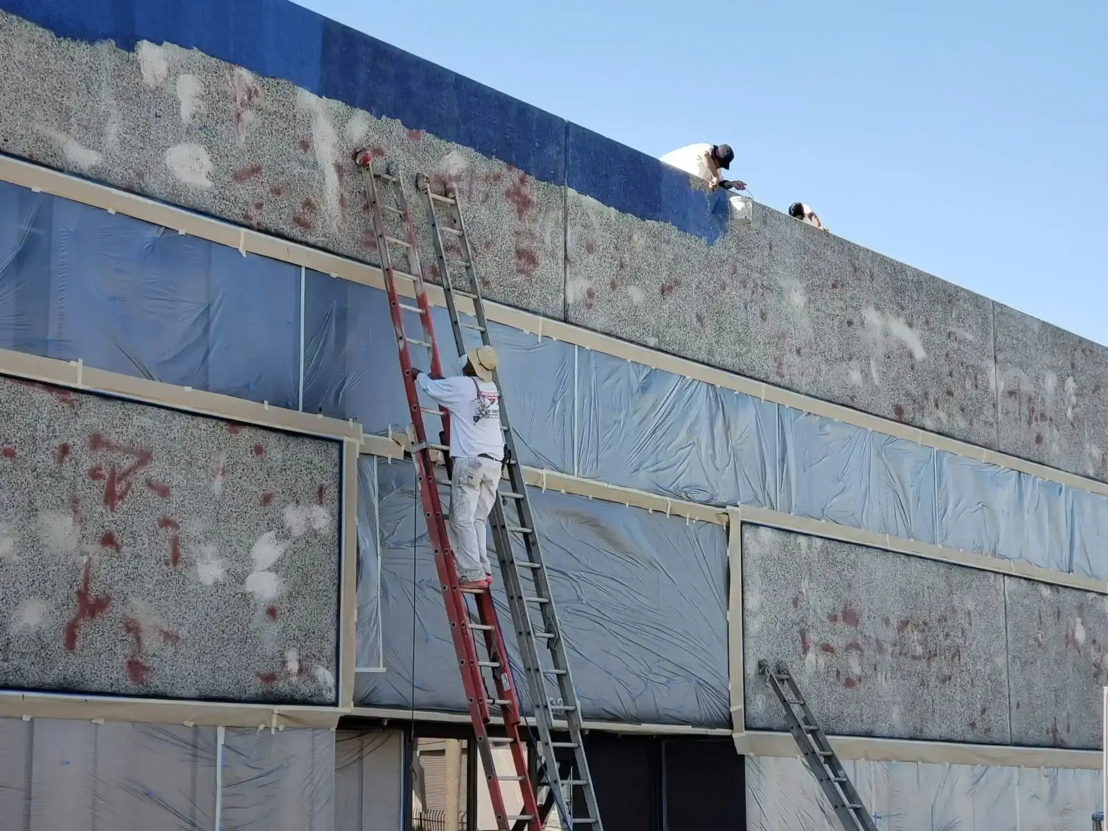 A painter working on an exterior house painting project.