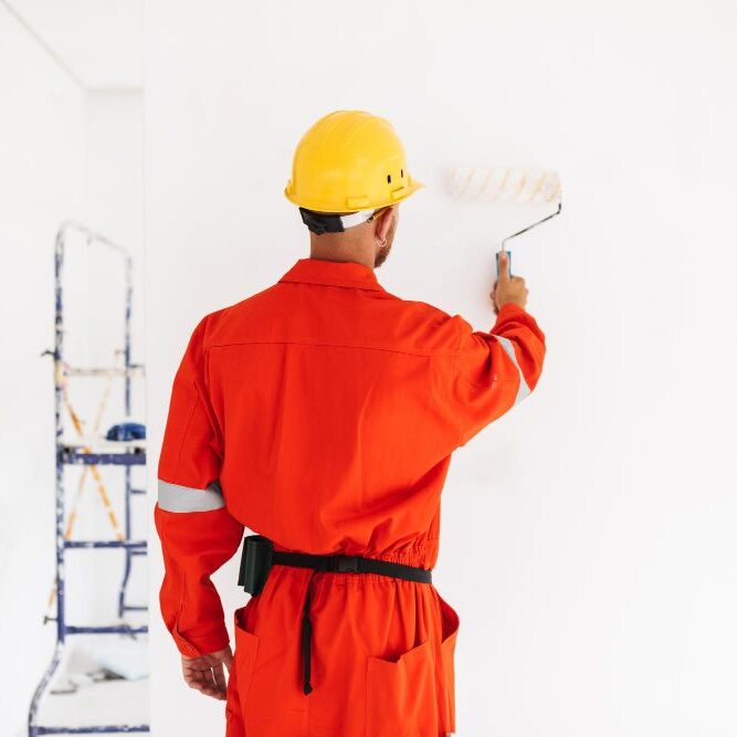 Professional painter applying a fresh coat of exterior painting.